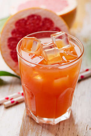 Glass of pink grapefruit juice. Selective focusの写真素材