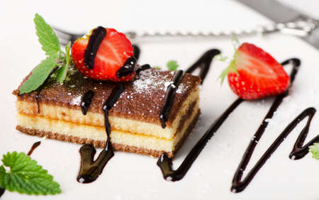 Cake with chocolate and berries on  white plate. Selective focusの写真素材