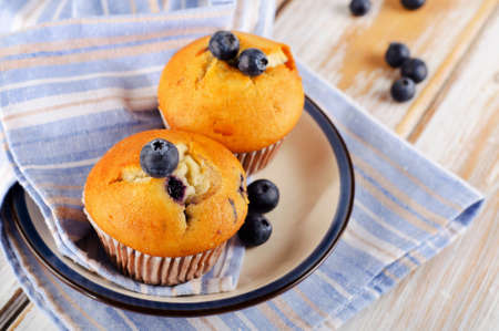 Homemade Muffins with fresh blueberries on a wooden table. Selective focusの写真素材