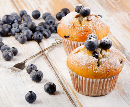 Blueberries muffins   on   wooden background. Selective focusの写真素材