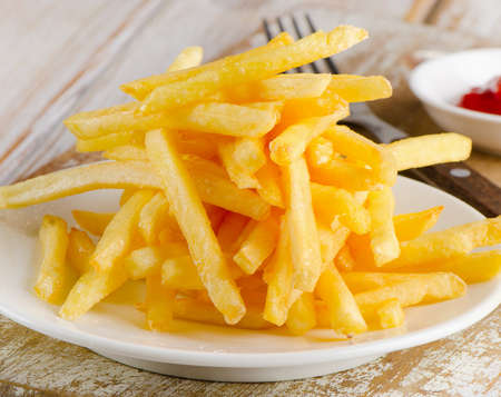 French fries on a  wooden table. Selective focusの写真素材
