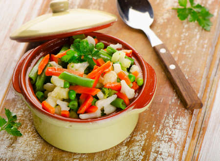 Mixed vegetables in  bowl on a wooden background. Selective focusの写真素材