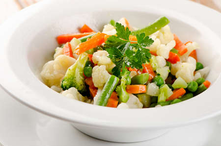 Mixed vegetables in a white  bowl . Selective focusの写真素材