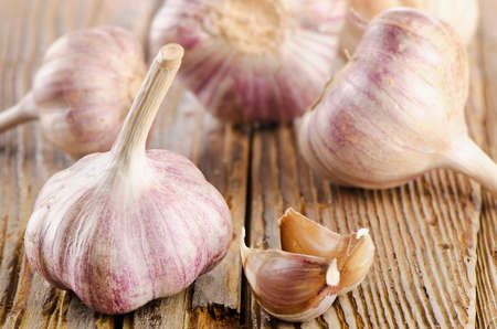 garlic whole and cloves on  wooden table. selective focusの写真素材