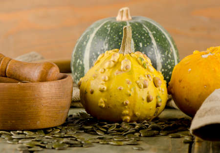 Yellow and green Pumpkins and seeds  on  a wooden table. Selective focusの写真素材