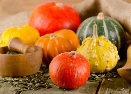 Mixed Pumpkins and seeds  on a wooden background. Selective focusの写真素材