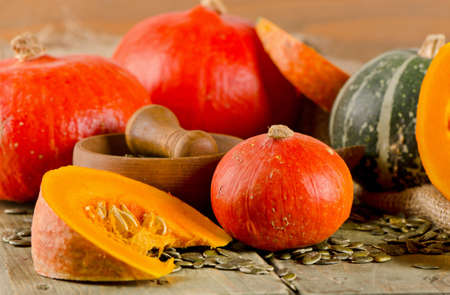 Mixed Pumpkins and seeds  on  wooden background. Selective focusの写真素材