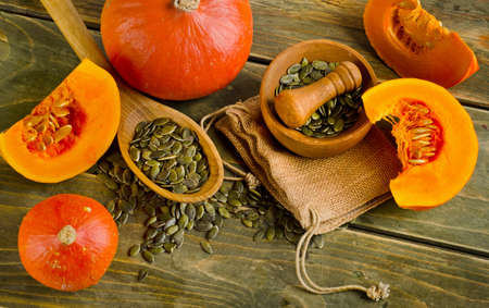 Pumpkins and seeds  on a wooden background. Selective focusの写真素材