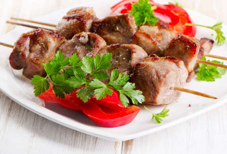 Pork kebabs served on a  white plate. Selective focusの写真素材