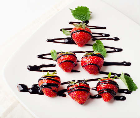Strawberries  in chocolate sauce on  white plate. Selective focusの写真素材