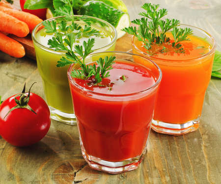 vegetables  juices on a wooden table. Selective focusの写真素材