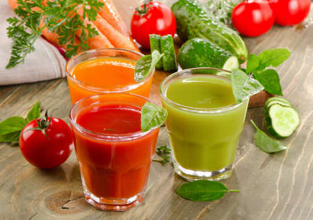 Fresh vegetables  juices on a wooden background. Selective focusの写真素材