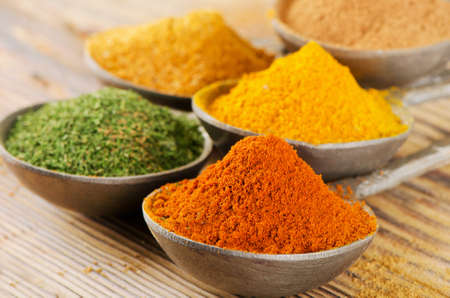 Various spices selection on a wooden bakground. Selective focusの写真素材