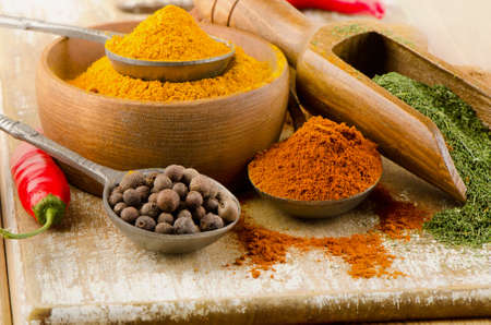 Ground spices on spoons on a wooden backgroundの写真素材