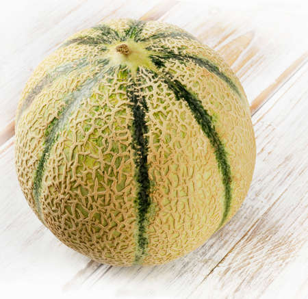 Whole melon  on the wooden background. Selective focusの写真素材