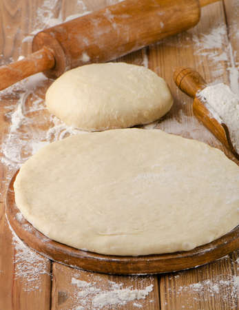 pizza dough on a wooden background. selective focusの写真素材