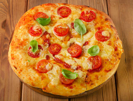 Homemade  pizza with tomatoes on  wooden background. Selective focusの写真素材