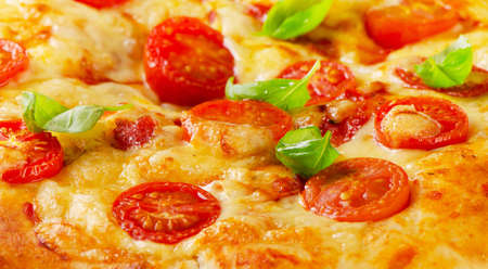 Italian pizza with tomatoes on a wooden background. Selective focusの写真素材