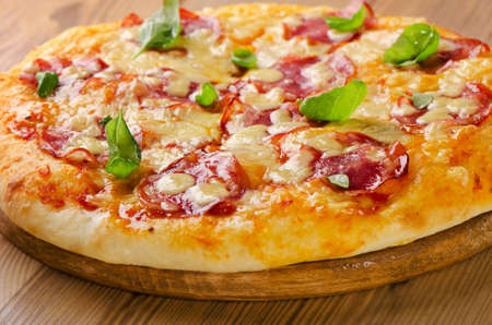 Salami pizza on  wooden  board. Selective focusの写真素材
