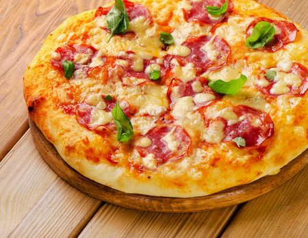 Fresh homemade salami pizza on a wooden  board. Selective focusの写真素材