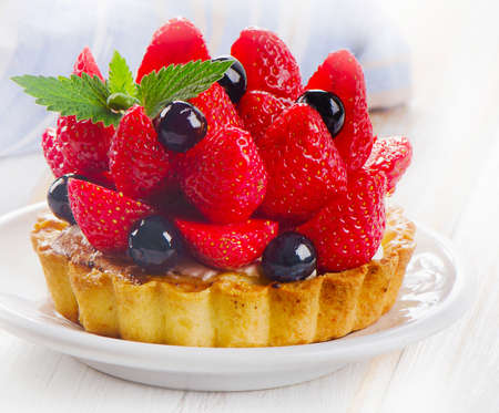 Fresh berries cake on a white plate. Selective focusの写真素材
