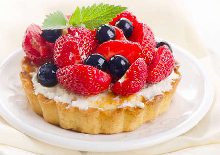 Fresh strawberry tart on a white plate.の写真素材