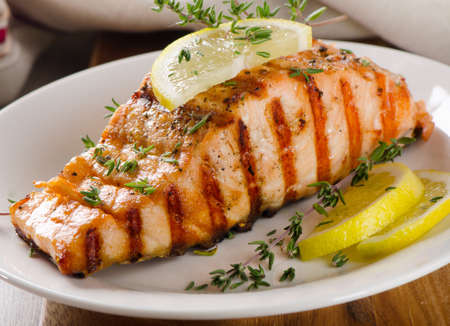 Grilled Salmon with lemon, olives and  thyme. Selective focusの写真素材