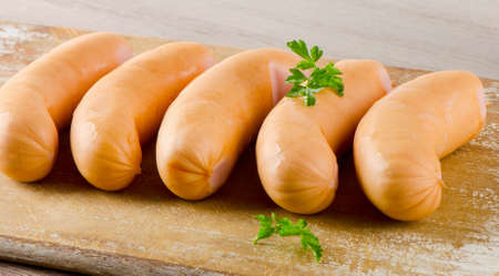 Sausages with fresh herbs on a cutting board. Selective focusの写真素材