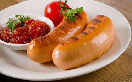 Roasted sausages with tomato sauce.Selective focusの写真素材