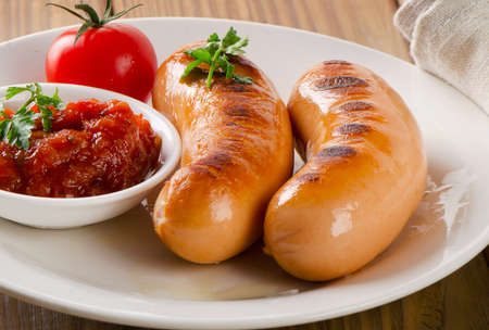 Roasted sausages with tomato sauce and herbs.Selective focusの写真素材