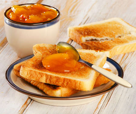 Slices of toast bread on a wooden table. Selective focusの写真素材