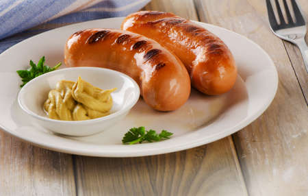 Two sausages with mustard sauce. Selective focusの写真素材