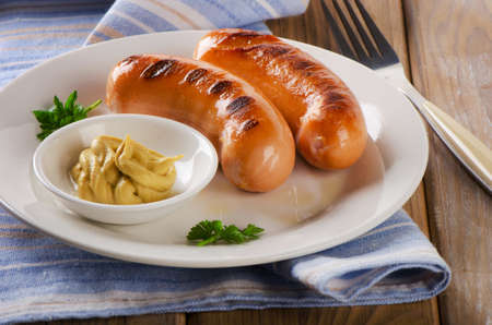 Two grilled sausages with mustard . Selective focusの写真素材