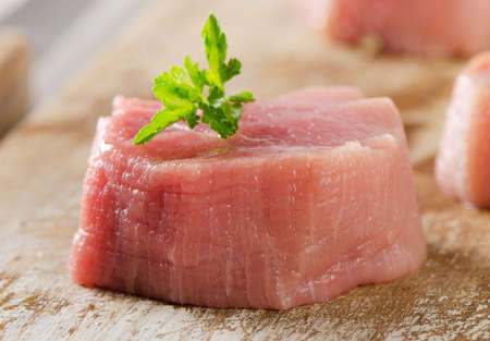Raw beef with herbs on  wooden background. Selective focusの写真素材