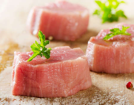 Raw beef with herbs on a wooden background. Selective focusの写真素材