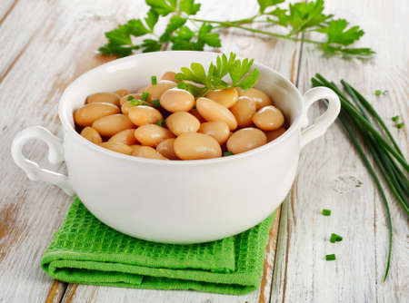 Beans  with fresh herbs  on  wooden table . Selective focusの写真素材