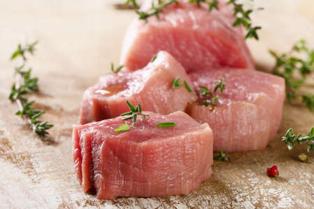 Beef with thyme on a cutting board. Selective focusの写真素材