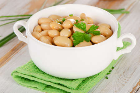 Beans  with  herbs  on  wooden table . Selective focusの写真素材