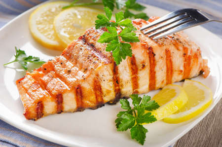 Grilled Salmon with lemon and   herbs . Selective focusの写真素材