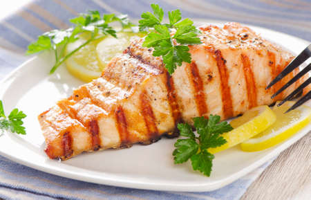 Grilled Salmon with lemon and  fresh herbs . Selective focusの写真素材