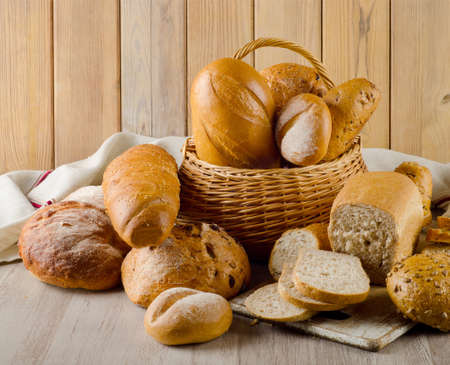 Different types of bread on  a wooden backgroundの写真素材