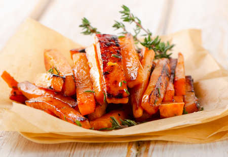 sweet potato fries on a wooden table . Selective focus