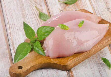 Raw chicken breast fillets on a cutting board. Selective focusの写真素材