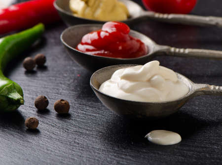 Mustard, tomato sauce and mayonnaise on  black table. Selective focusの写真素材