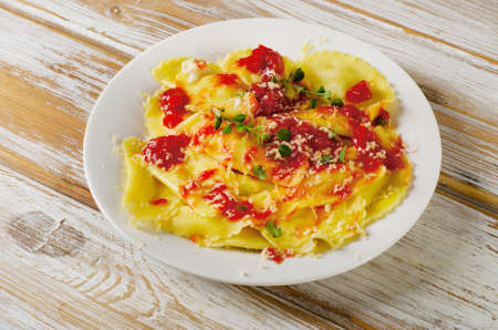 ravioli pasta with a tomato sauce on wooden table. Selective focusの写真素材