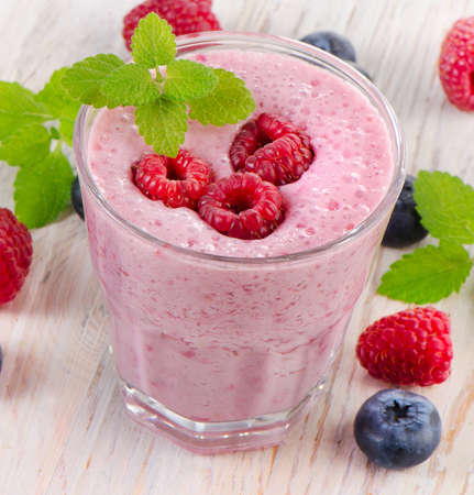 Raspberry smoothie with  berries on  wooden table . Selective focusの写真素材
