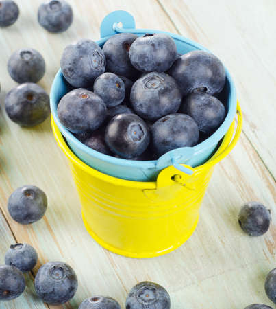 Blueberries in  buckets on a wooden table. Selective focusの写真素材