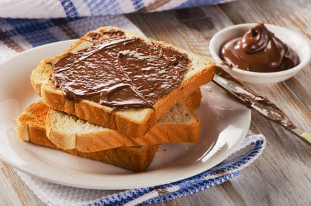 Fresh Toast with chocolate spread on a white plate.の写真素材