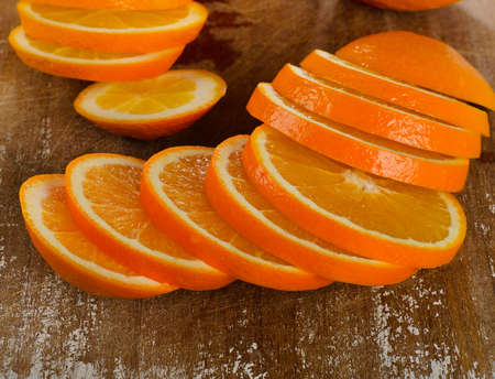 Slices of fresh orange on  wooden table . Selective focus