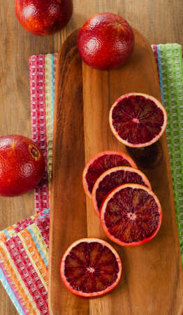 Fresh blood oranges  on a wooden cutting board. top wievの写真素材